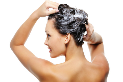 Portrait of young beautiful woman washing her head